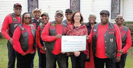 Nov. 7 United Eagles Motorcycle Club presenters included, front, holding check, Saunders Hodges, left, and JR Harris; other club members and American Cancer Society rep Mary Taylor, center, look on in the background.