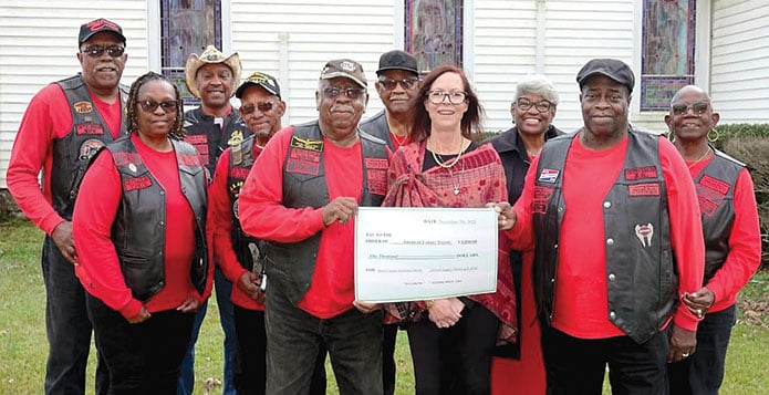 Nov. 7 United Eagles Motorcycle Club presenters included, front, holding check, Saunders Hodges, left, and JR Harris; other club members and American Cancer Society rep Mary Taylor, center, look on in the background.