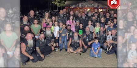 Motorcycle club accused of kidnapping 22 children posed in picture with children